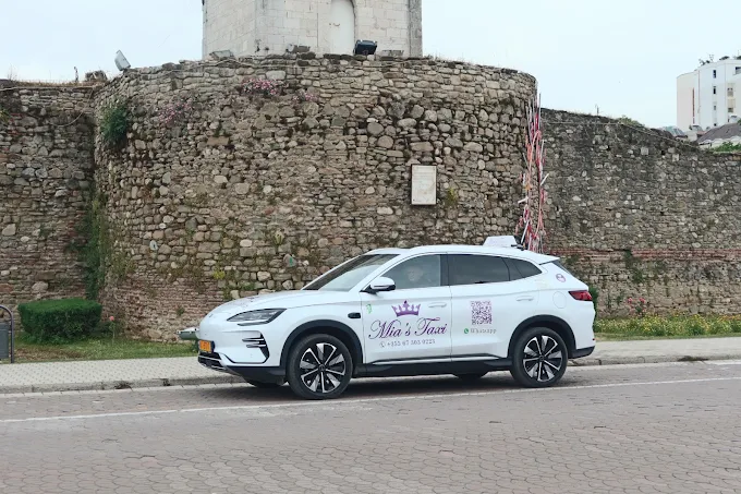 Mia's Taxi parked by the Elbasan castle walls